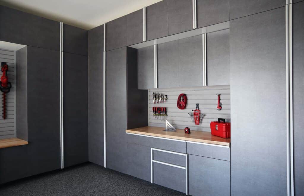 Image of a fully finished Pewter-Cabinets-with-Butcher-Block-Countertop-and-Grey-Slatwall-Closeup-Angle-June-2021